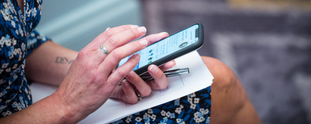 Woman Scrolling on Phone, Photo Credit: Focus Photography